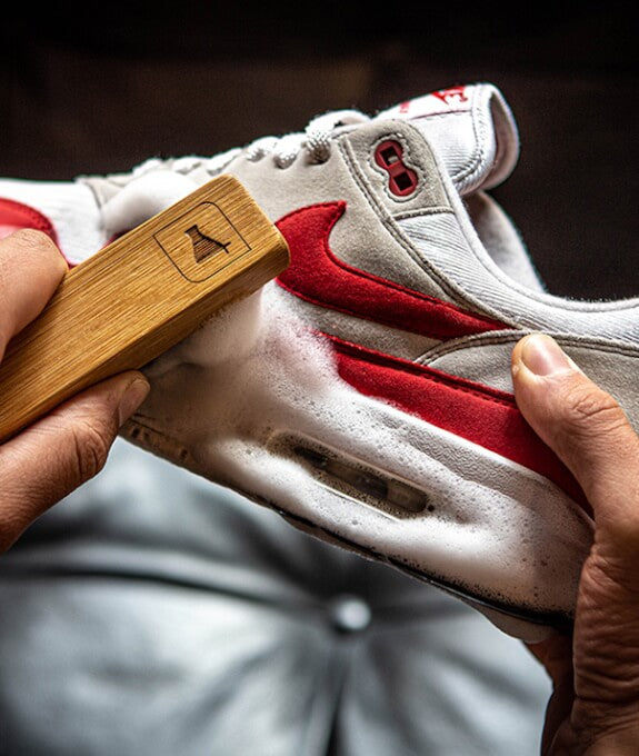 Opening visual in the clean, care, protect series showing a sneaker mid-clean as dirt starts lifting from the surface of the shoe